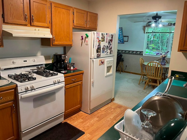 kitchen featuring white appliances, light hardwood / wood-style floors, and ceiling fan