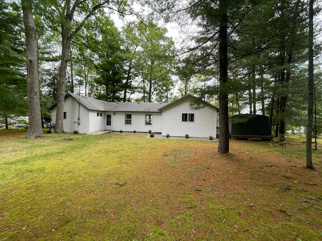 rear view of house featuring a lawn