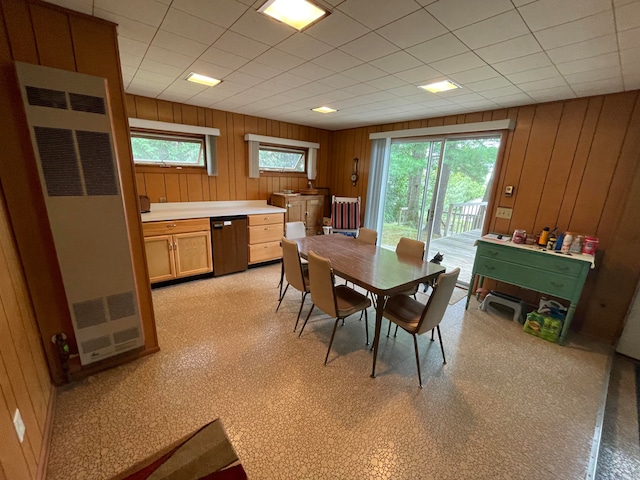 dining space featuring plenty of natural light and wooden walls