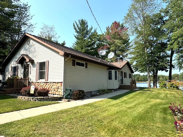 view of side of property with a lawn