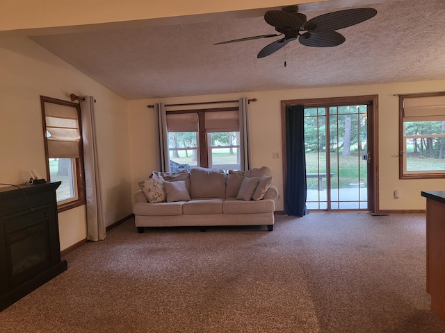 carpeted living room with a textured ceiling, ceiling fan, and lofted ceiling