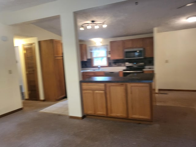 kitchen with light carpet, stainless steel appliances, and tasteful backsplash