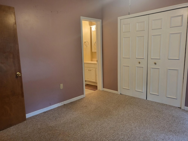 unfurnished bedroom with light carpet, connected bathroom, and a closet