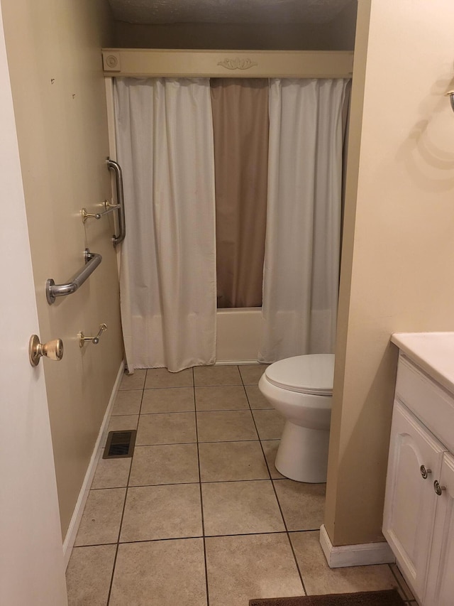 full bathroom featuring toilet, vanity, tile patterned floors, and shower / bath combo with shower curtain