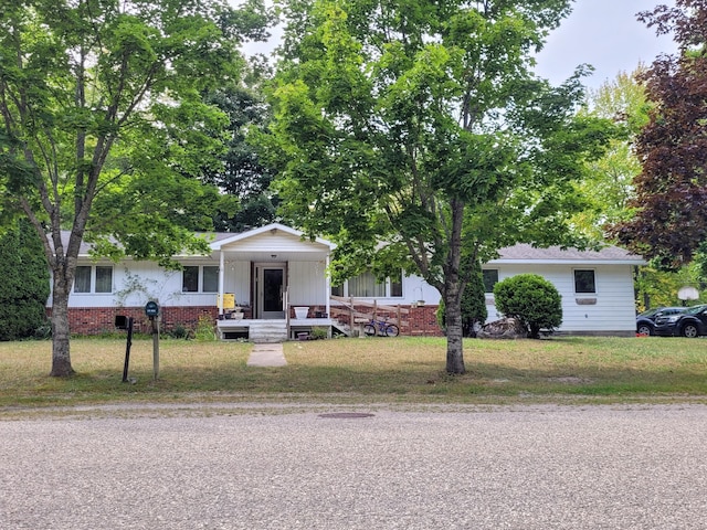 single story home featuring a front yard and covered porch