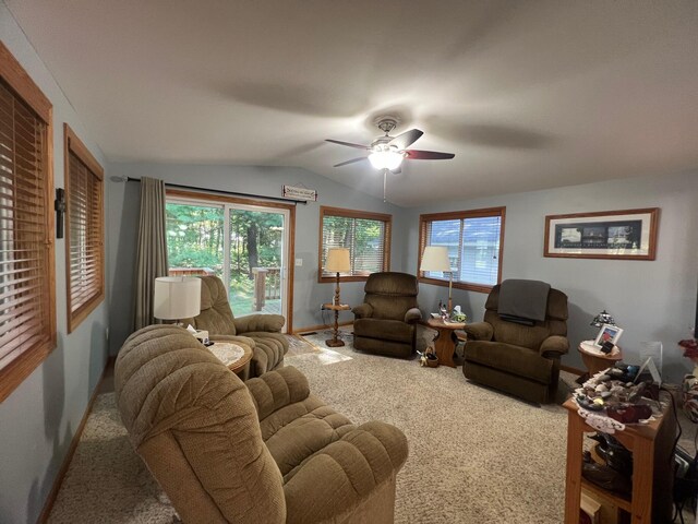 living room with vaulted ceiling, a healthy amount of sunlight, ceiling fan, and carpet