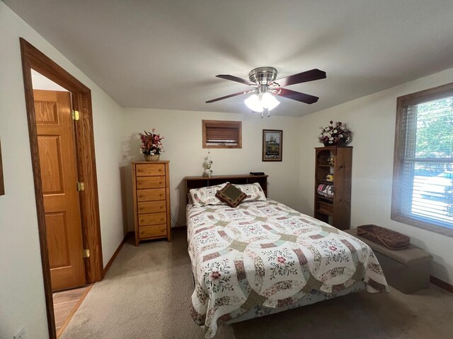 bedroom featuring ceiling fan and light carpet