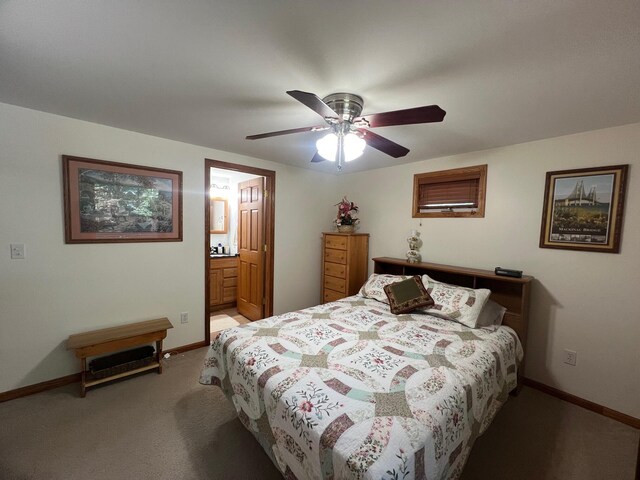 bedroom with ceiling fan, ensuite bathroom, and light carpet