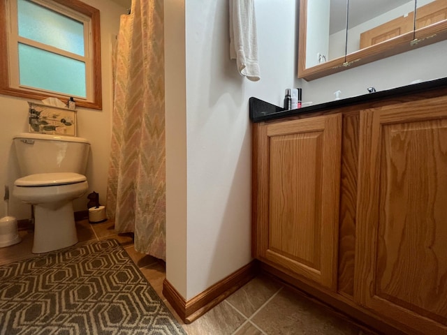 bathroom with tile patterned flooring and toilet