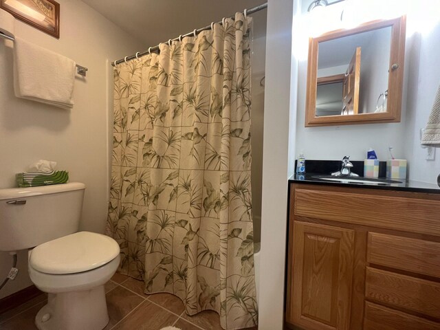 bathroom with tile patterned flooring, vanity, toilet, and a shower with shower curtain