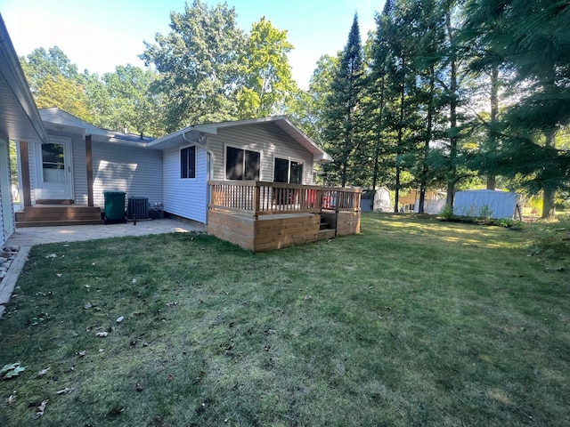 view of yard with a wooden deck, cooling unit, and a patio area