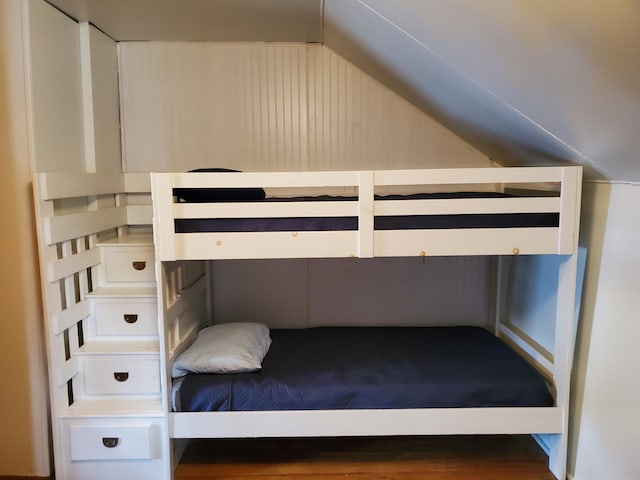 unfurnished bedroom featuring lofted ceiling and hardwood / wood-style floors