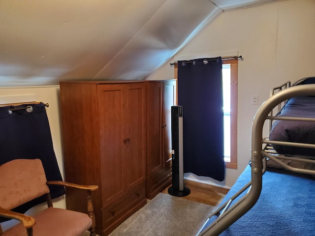 workout area with hardwood / wood-style flooring and vaulted ceiling