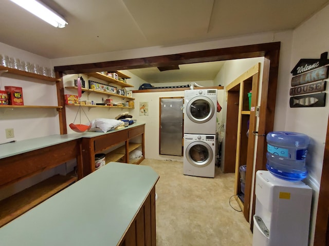 laundry area featuring stacked washer / drying machine