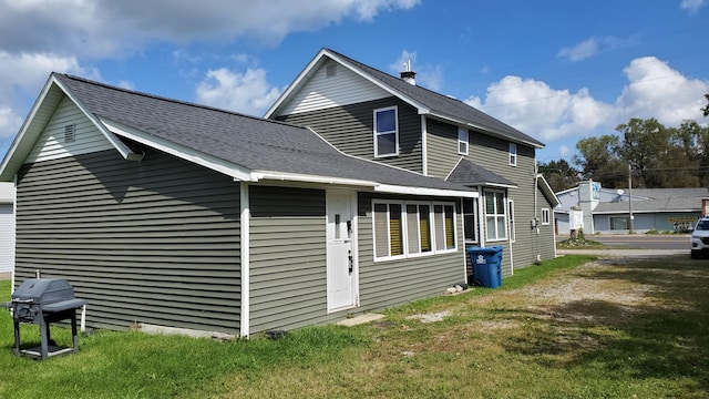 view of side of home featuring a lawn