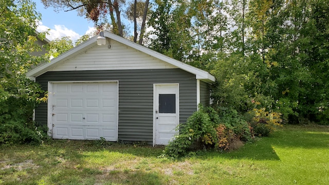 garage featuring a lawn