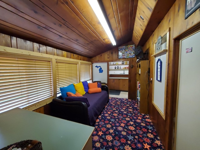 interior space featuring carpet, vaulted ceiling, wooden walls, and wood ceiling