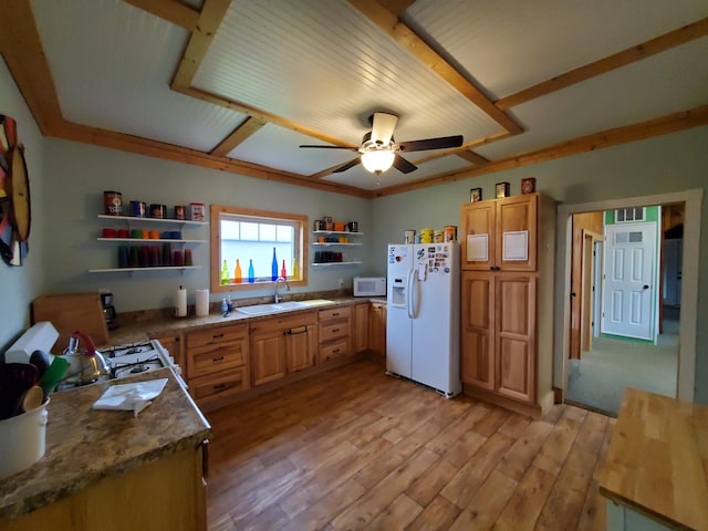 kitchen featuring white appliances, light hardwood / wood-style flooring, stone countertops, sink, and ceiling fan