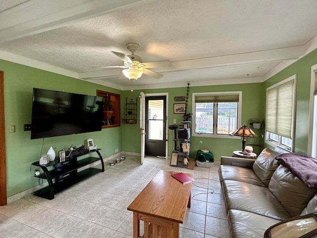 living room with ceiling fan, light tile patterned flooring, and a textured ceiling