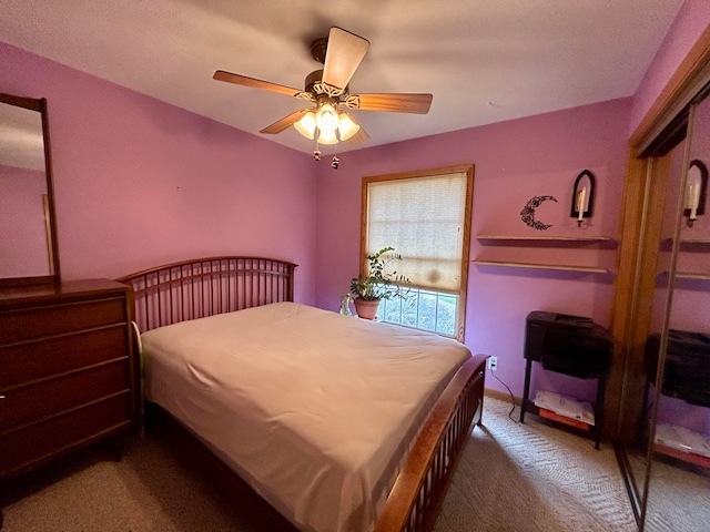 bedroom with ceiling fan and dark colored carpet