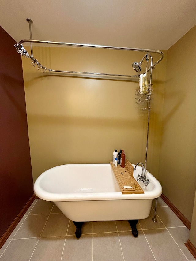 bathroom with a bath and tile patterned floors