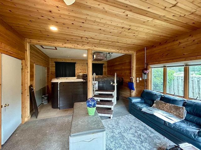 living room featuring wood ceiling, wood walls, and light carpet