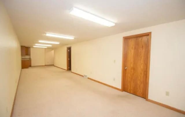 empty room featuring light carpet