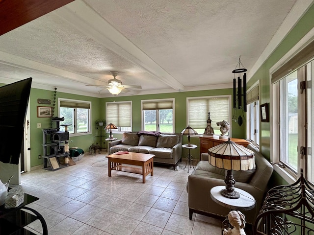 sunroom featuring ceiling fan, plenty of natural light, and beam ceiling