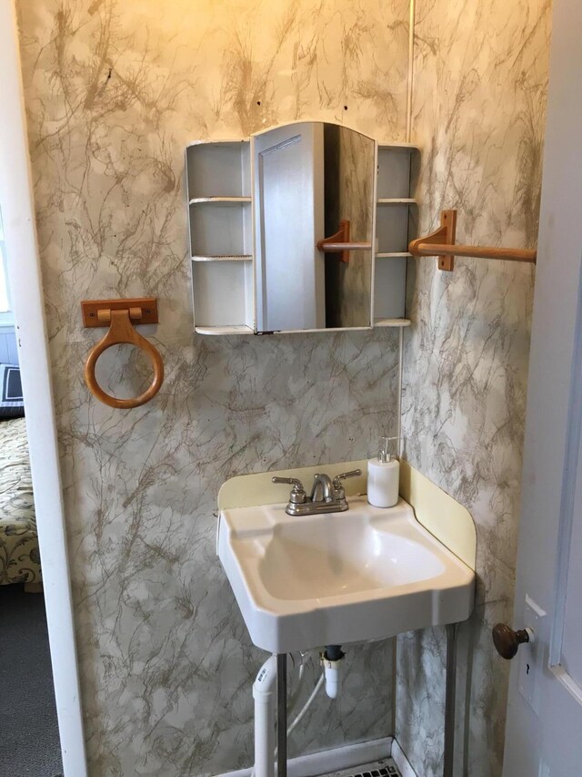 bathroom featuring tile walls and sink