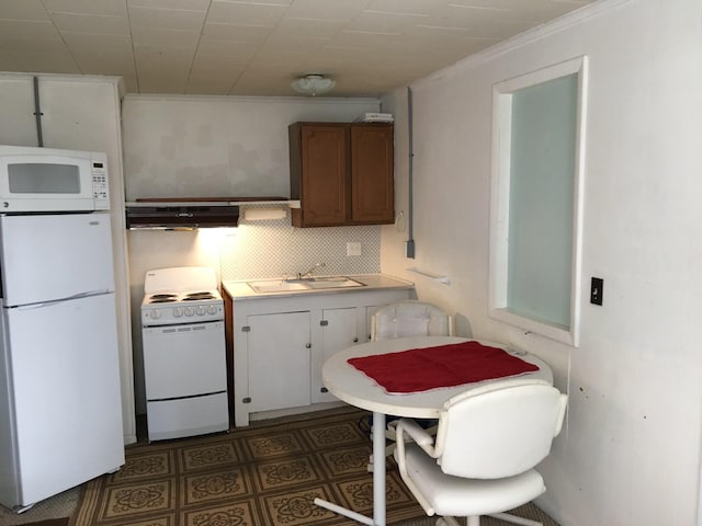 kitchen with white cabinets, tasteful backsplash, white appliances, crown molding, and sink