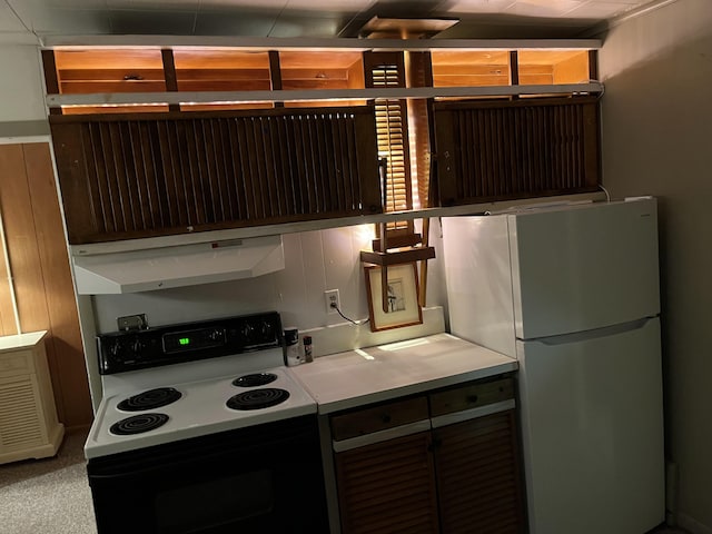 kitchen featuring white appliances and carpet floors