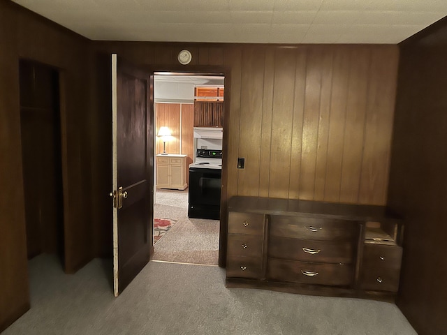 carpeted bedroom with wooden walls