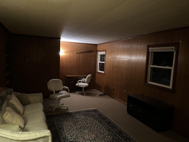 carpeted living room with wood walls