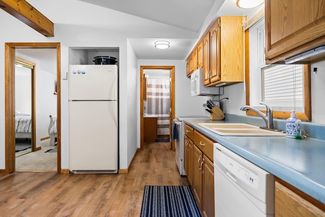 kitchen with light wood-type flooring, sink, white appliances, and lofted ceiling