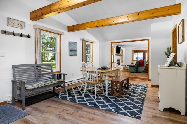 dining room with lofted ceiling with beams and hardwood / wood-style floors