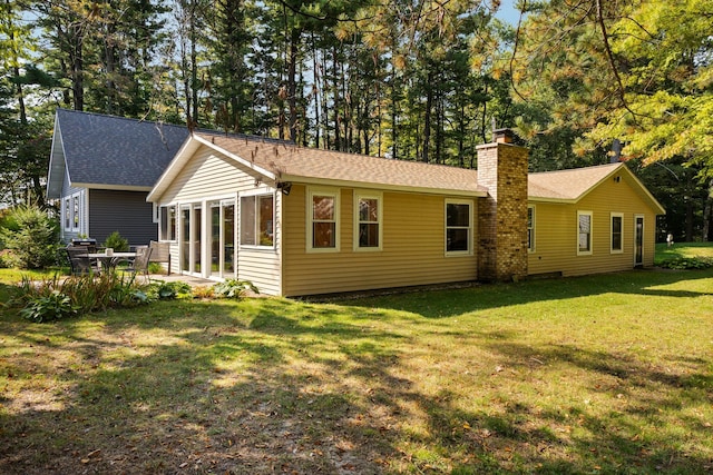 back of house with a lawn