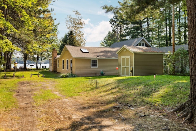 rear view of house with a lawn