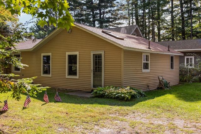 rear view of house featuring a yard