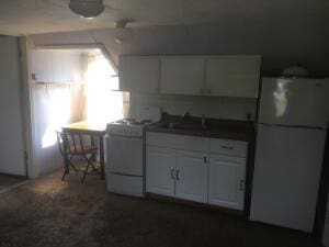 kitchen featuring white cabinets, white appliances, and sink