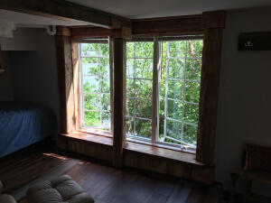 interior space with multiple windows and hardwood / wood-style flooring