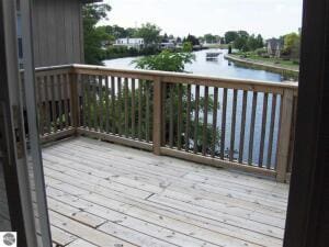 wooden deck featuring a water view