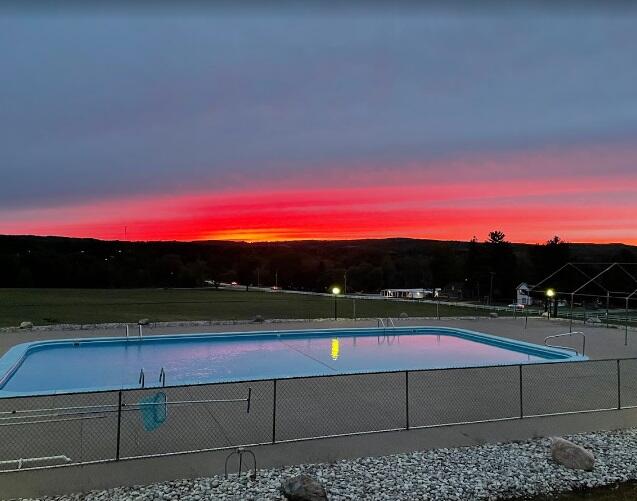 view of pool at dusk