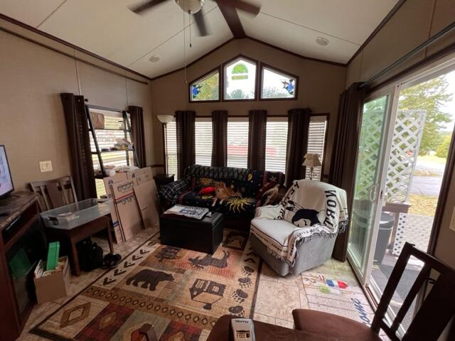 living room featuring vaulted ceiling and ceiling fan