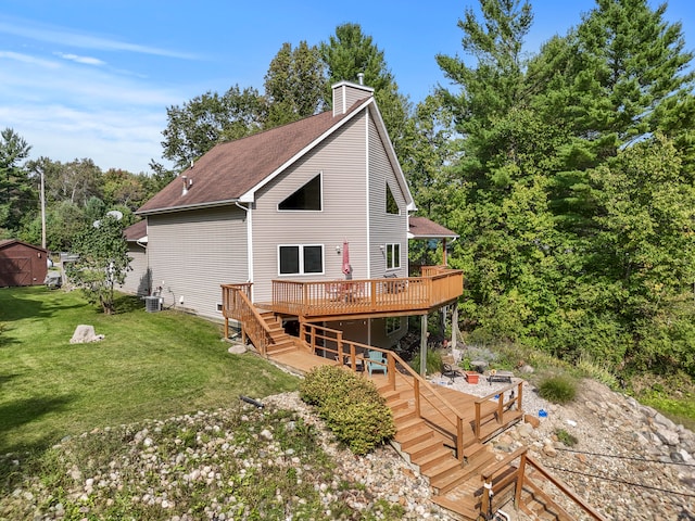 back of house featuring cooling unit, a lawn, a shed, and a deck