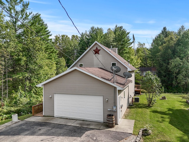 view of front of home featuring a garage, a front yard, a deck, and central air condition unit