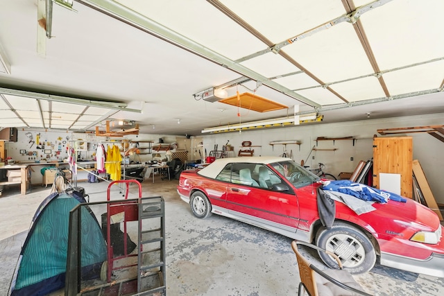 garage with a garage door opener and a workshop area