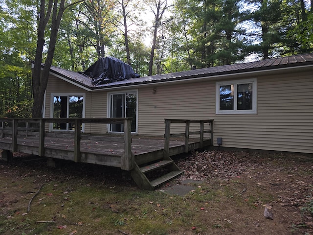 rear view of house featuring a wooden deck