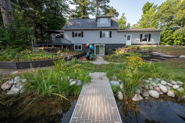 rear view of house featuring a wooden deck