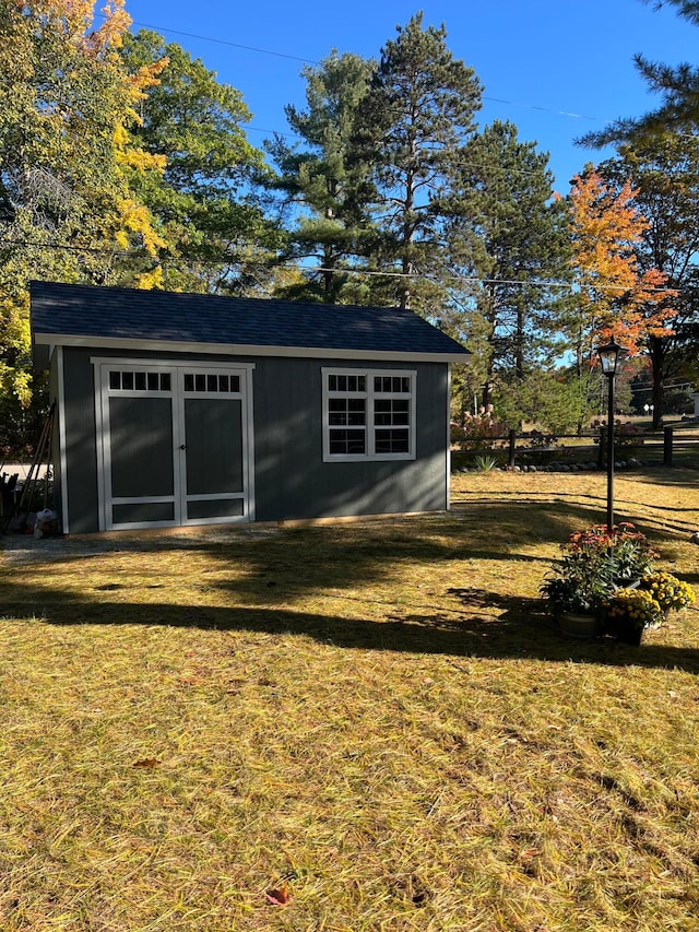 view of outbuilding featuring a yard