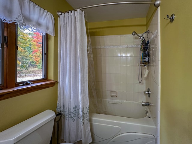 bathroom featuring toilet and shower / bath combo with shower curtain